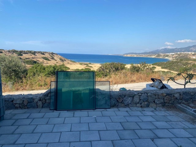 We are very Pleased to offer for sale this beautifully presented 3 bedroom townhouse with a location to live for. Situated on the seafront in Bahceli where the  aquamarines of the Mediterranean welcome you in  every room bar 1.  You also have in addition a large basement area with potential to conve