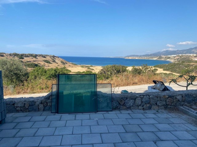 We are very Pleased to offer for sale this beautifully presented 3 bedroom townhouse with a location to live for. Situated on the seafront in Bahceli where the  aquamarines of the Mediterranean welcome you in  every room bar 1.  You also have in addition a large basement area with potential to conve