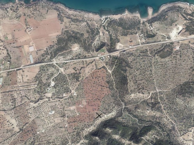 4 acres of 3 evlek (6355.50 m2) land with a beautiful sea view and a road is for sale in Tatlısu/Mağusa. Facebook: Seyland Real Estate, 05428800222