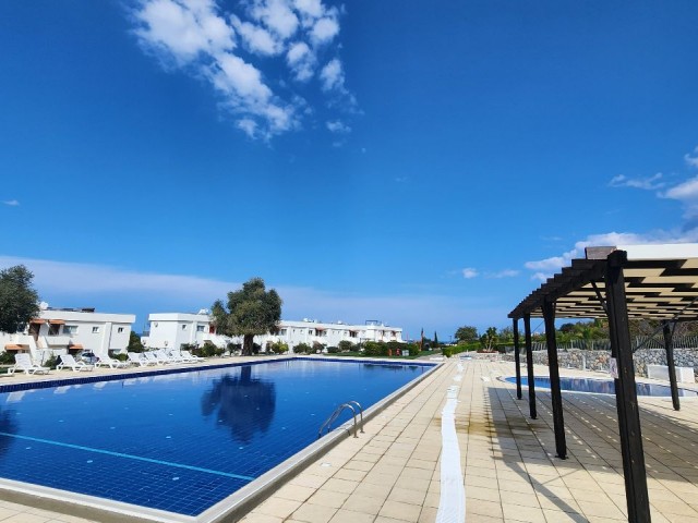 2+1 Flat for Sale with Sea and Nature Views in a Site with a Pool in Esentepe