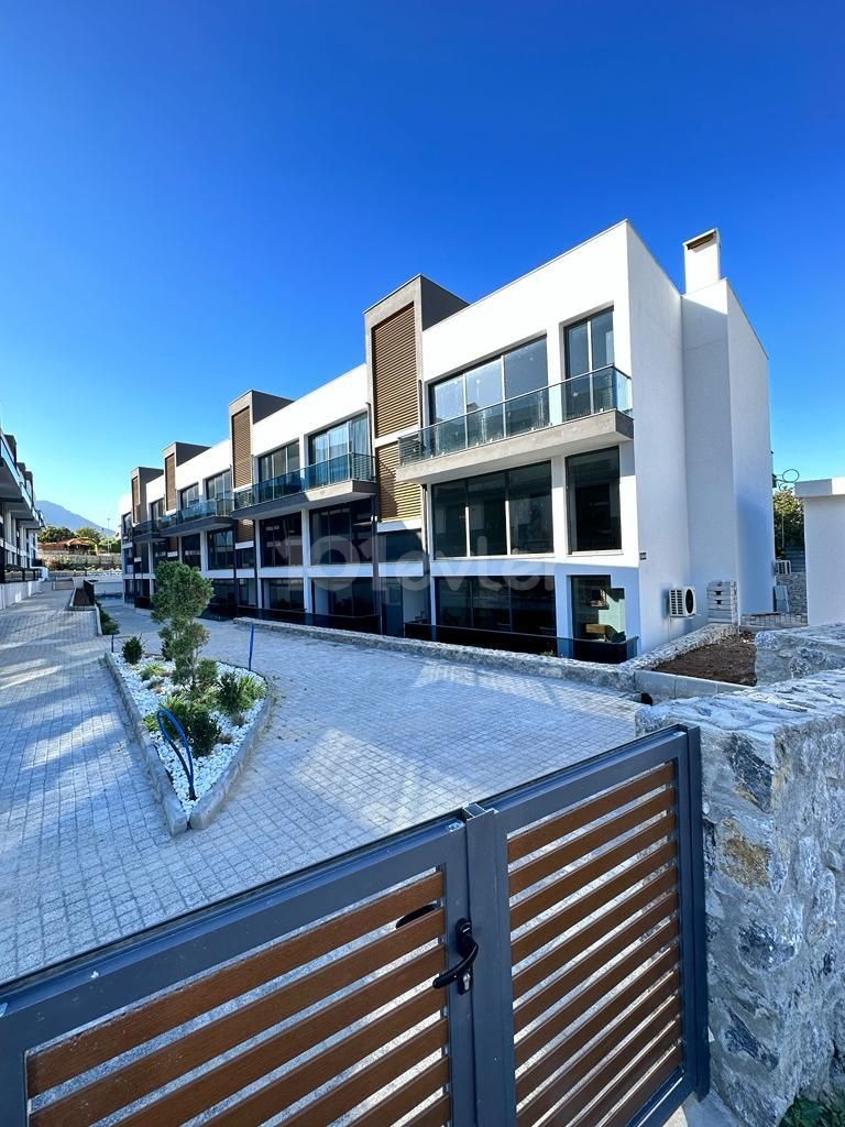 3+1 FLATS FOR SALE IN CYPRUS GIRNE ALSANCAK AREA, WITHIN A SITE WITH A POOL, WITH TERRACE OR GARDEN FLOOR OPTIONS, WITH MOUNTAIN AND SEA VIEWS, OFFERING A TURN KEY 12 MONTHS PAYMENT AFTER 50% PAYMENT.