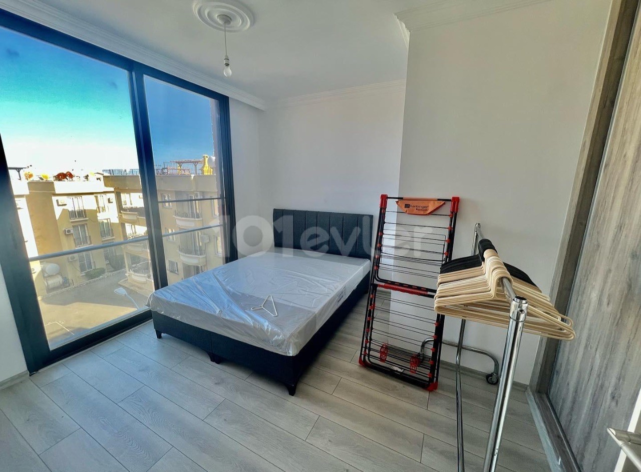 2+1 FLAT IN ALSANCAK WITH SPACIOUS TERRACE AND COMMUNAL SWIMMING POOL 