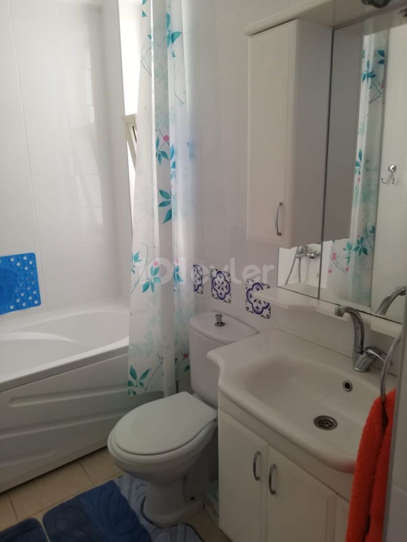 Kyrenia - Esentepe, furnished, 2+1 flat with white goods and private garden. It is 300 meters from the sea. We can speak Turkish, English and Russian.