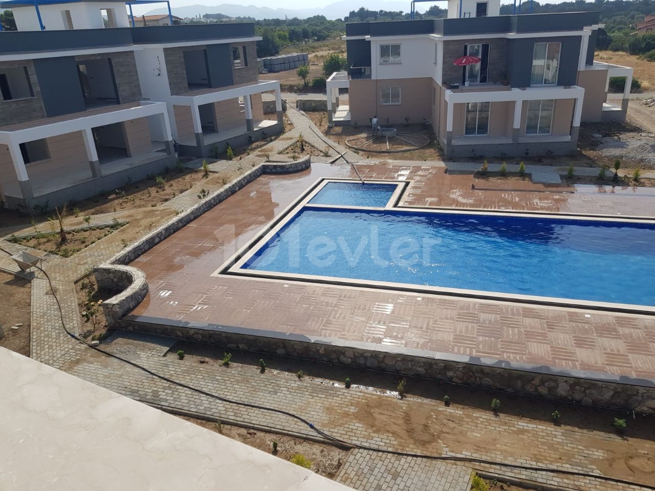 Turkish deed apartments in a complex with a pool, 300 meters from the sea in Karsiyaka, Girne. With ground floor or upper floor terrace options. 05338403555 ** 