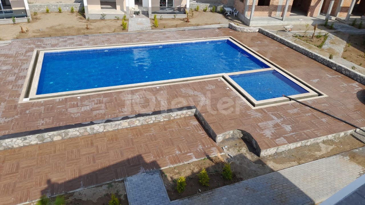 Turkish deed apartments in a complex with a pool, 300 meters from the sea in Karsiyaka, Girne. With ground floor or upper floor terrace options. 05338403555 ** 