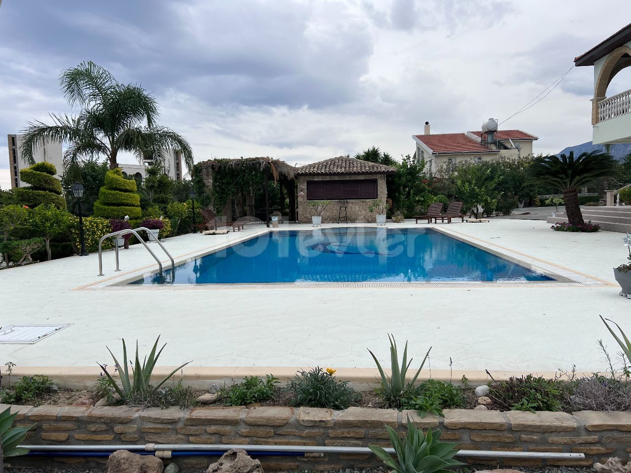 Turkish title Villa for sale in Lapta in 3144m2 land(aprox 2,5 donum of land) Gorgeous garden that makes you feel like in a botanical garden, pool bar&kitchen, water well and a lot of details need to be seen. 05338403555