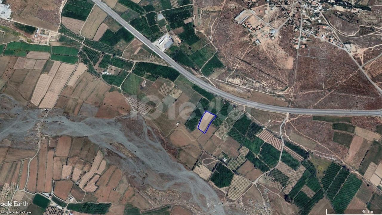 A Field for Sale by the Main Road at the Entrance to Güzelyurt ** 