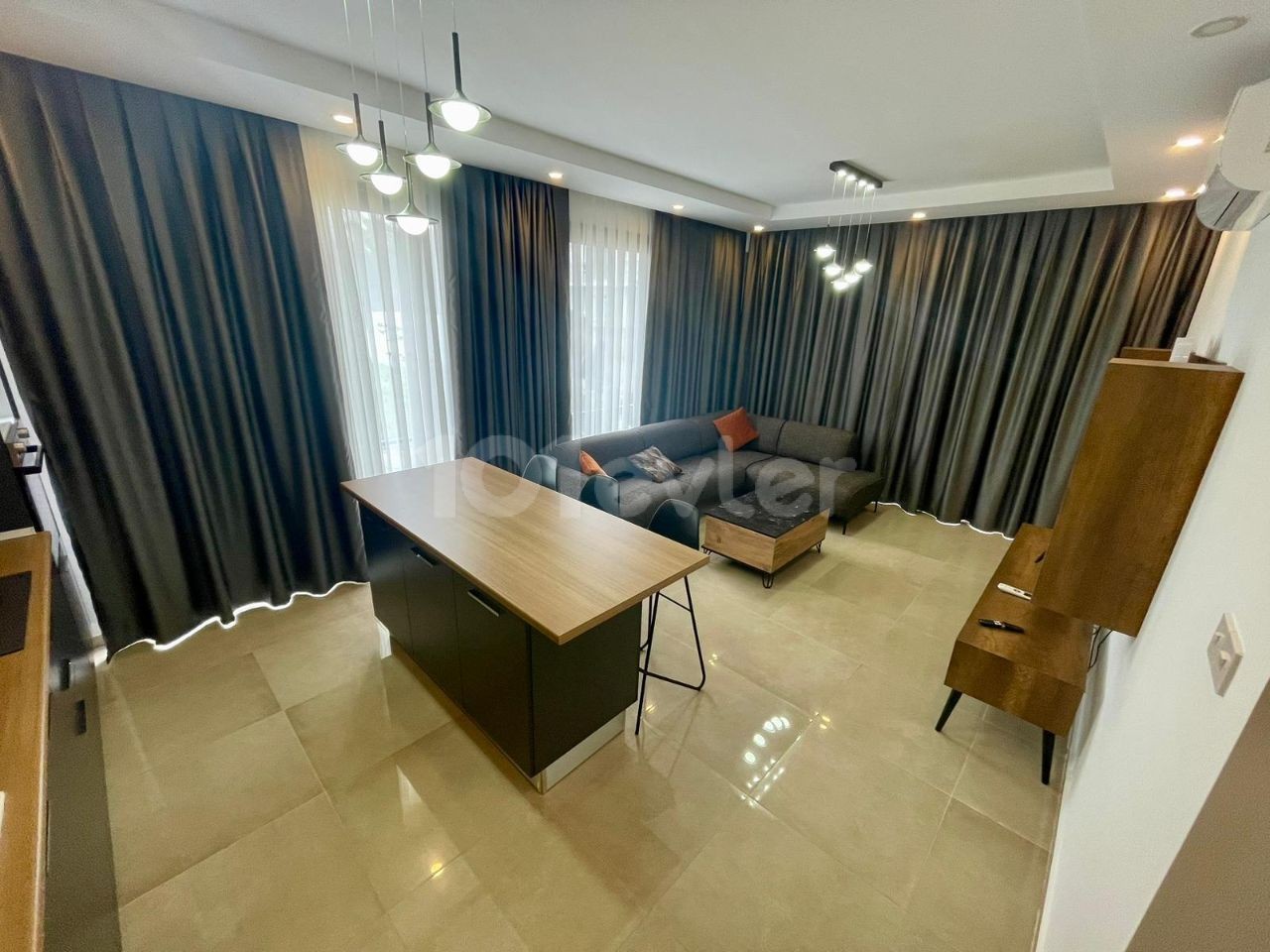 FOR THOSE LOOKING FOR A LOW FLOOR. .  FULLY FURNISHED LUXURIOUS 2+1 APARTMENT WITH ATTRACTIVE ADVANTAGES SUCH AS AIR CONDITIONING IN EVERY ROOM, LARGE SCREEN LCD TV, LAUNDRY ROOM, PARKING LOT, COMMUNAL POOL, WHICH EXHIBITS A UNIQUE BLUE AND GREEN VIEW TOGETHER, CLOSE TO THE CITY LIFE IN THE OLIVE GI