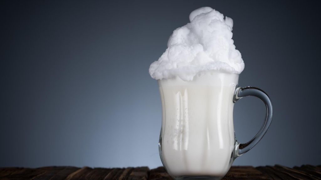 a mug of milk with a white substance on top