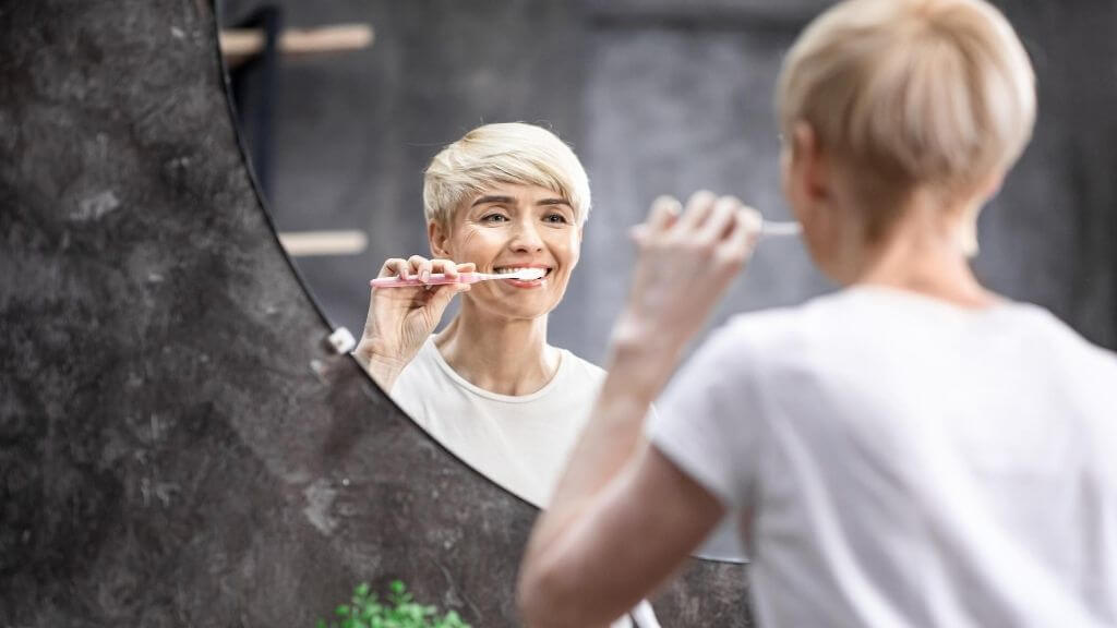 a woman brushing his teeth