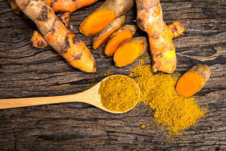 a group of carrots and a spoon on a table