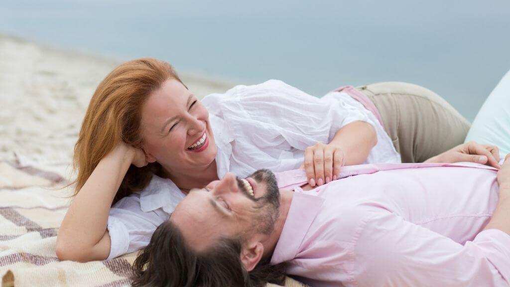 a man and woman lying on a bed