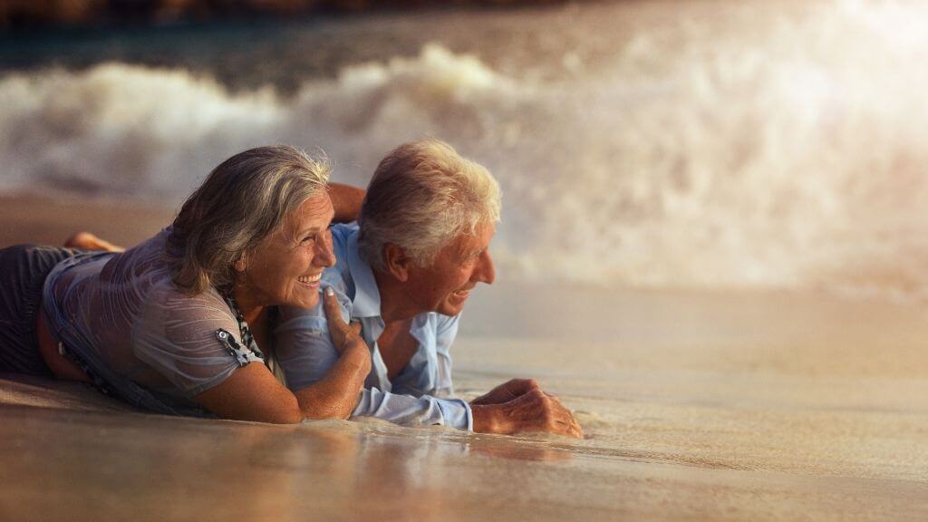 a man and woman sitting in the water