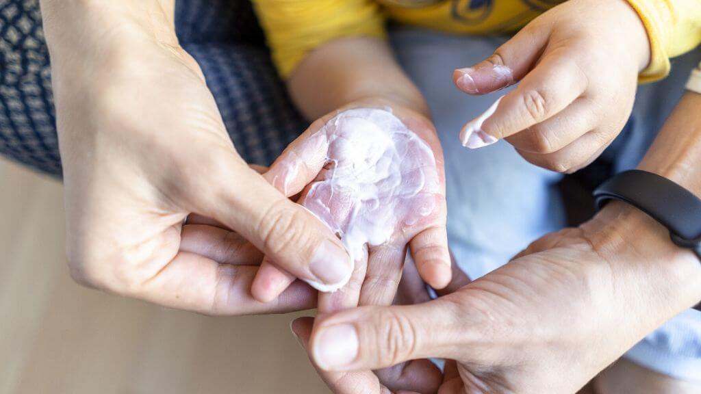 a person holding a baby's hand