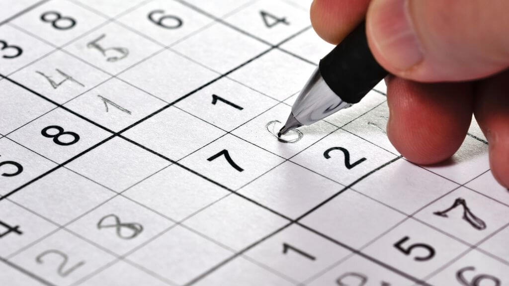 Man working on a sudoku