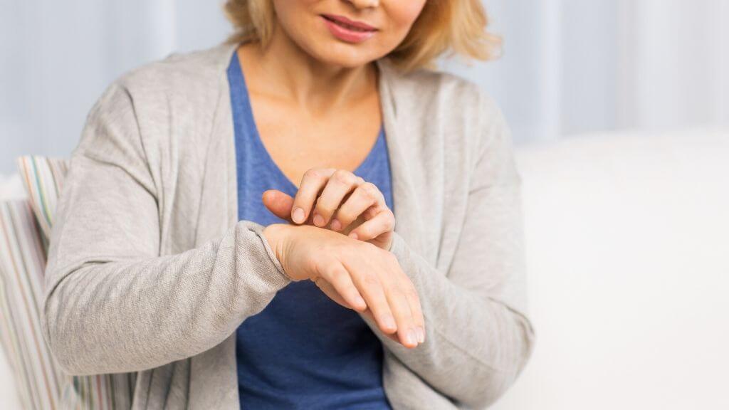 Woman itching her hand