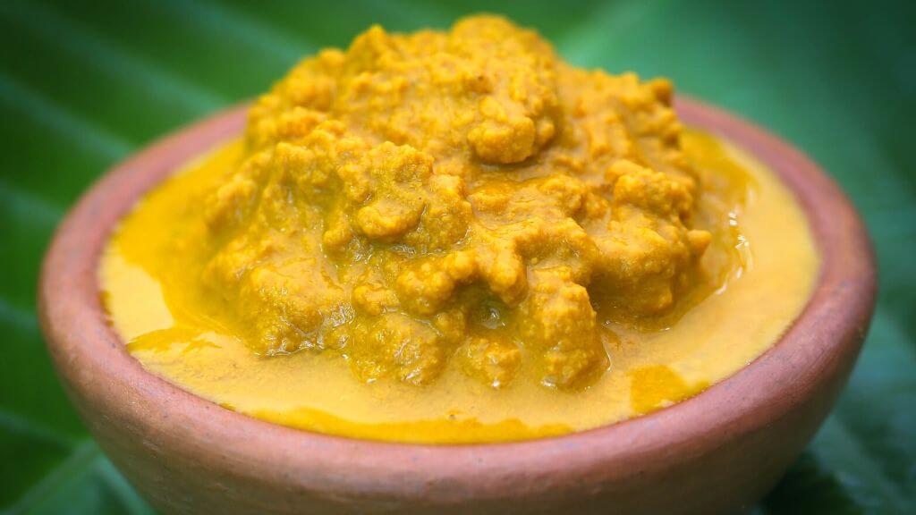 Mashed turmeric in a clay bowl