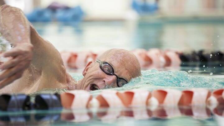 Senior man swimming in a lap lane