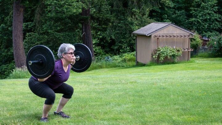 Senior woman strength training in her back yard