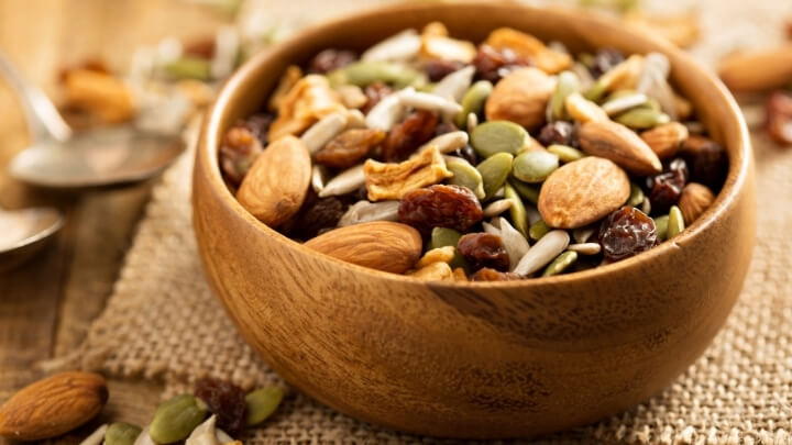 Nuts and dry fruits in wooden bowl