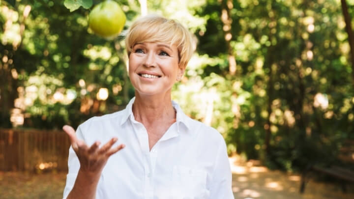 Senior woman about to enjoy an apple