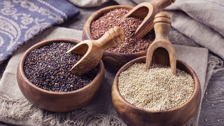 Tri-color quinoa in separate wood bowls