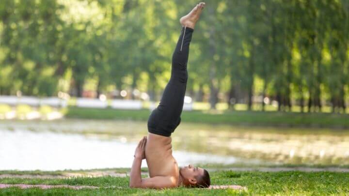 Man doing shoulder stand (salamba sarvangasana)