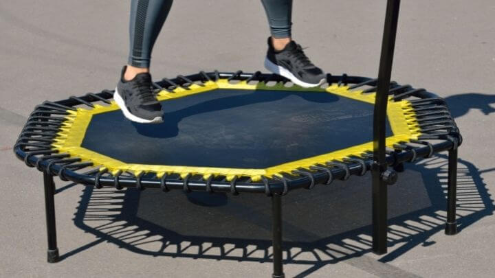 A woman rebounding on a mini trampoline