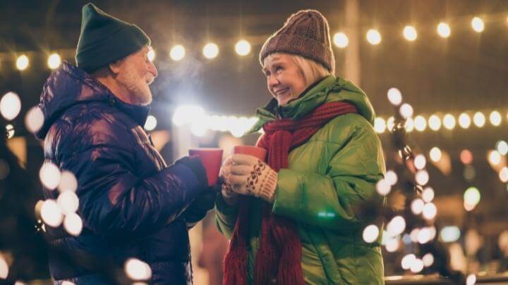 Elderly couple in their warm clothes outside enjoying the Holiday Season