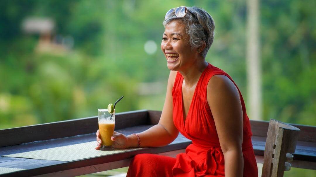 healthy middle aged woman enjoying a smoothie