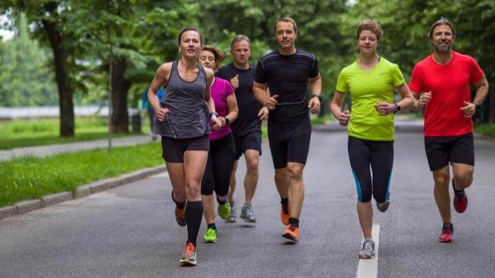 Middle aged friends jogging together