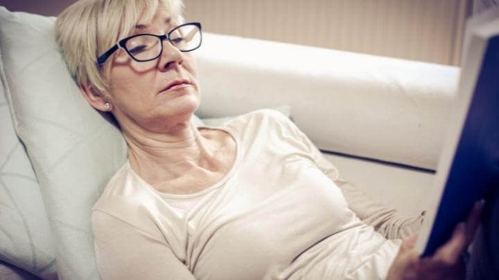 Woman relaxing while reading a book