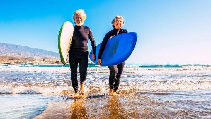 older couple with their surf boards