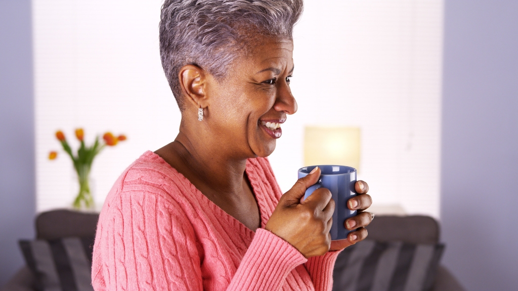 An older woman drinking guava leaves tea