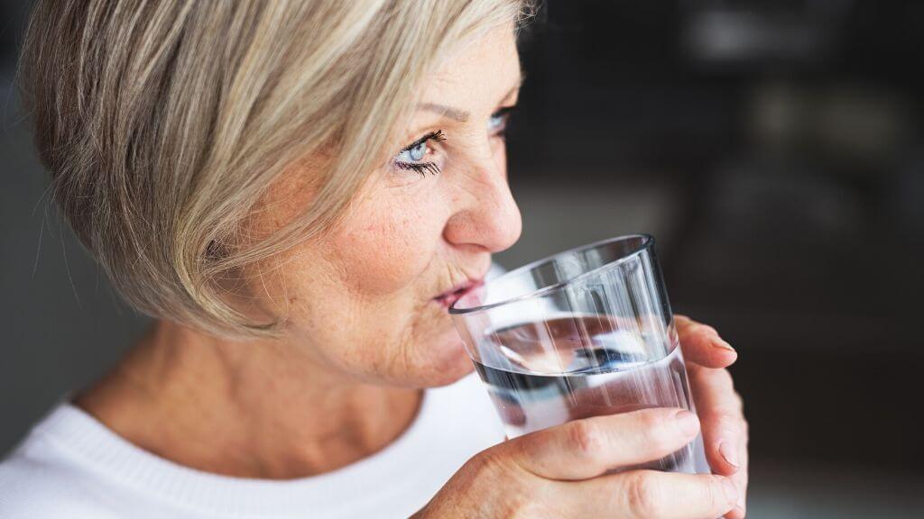 a person drinking from a glass