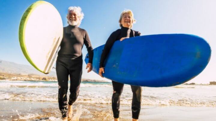 Elderly surfer couples at the beach