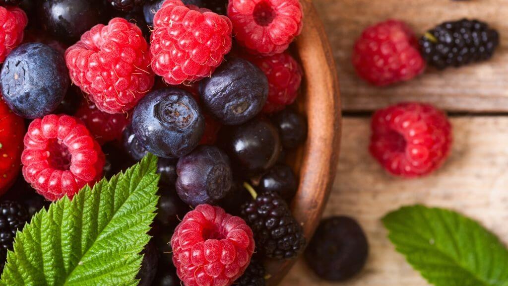 a group of berries on a wooden surface