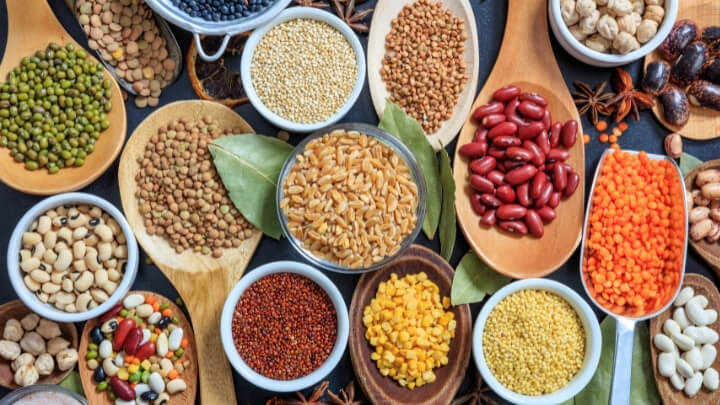 A variety of legumes on wooden spoons