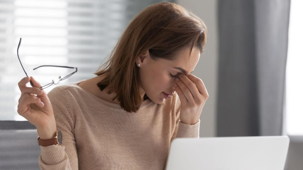 a woman holding a pair of glasses