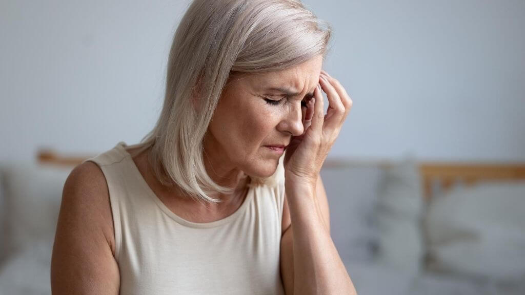 a woman with her hand on her face