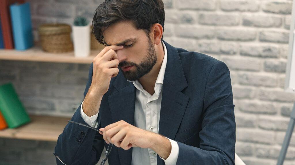 a man with a beard looking at his phone