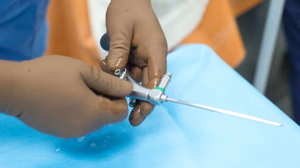 close-up of a person's hands holding a syringe