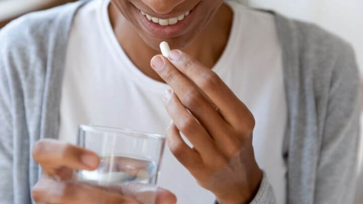 a person holding a glass of water