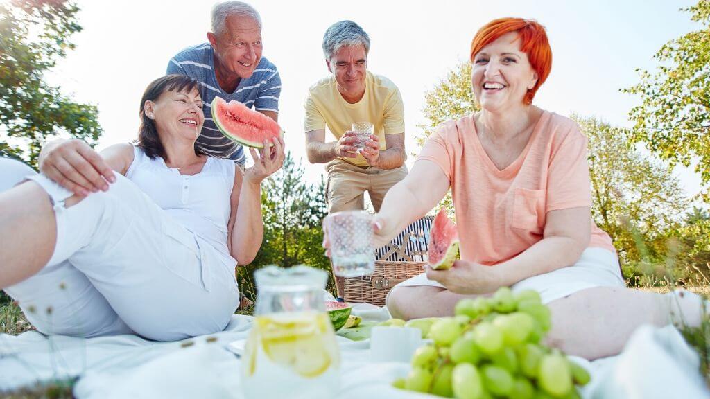 a group of people holding watermelons