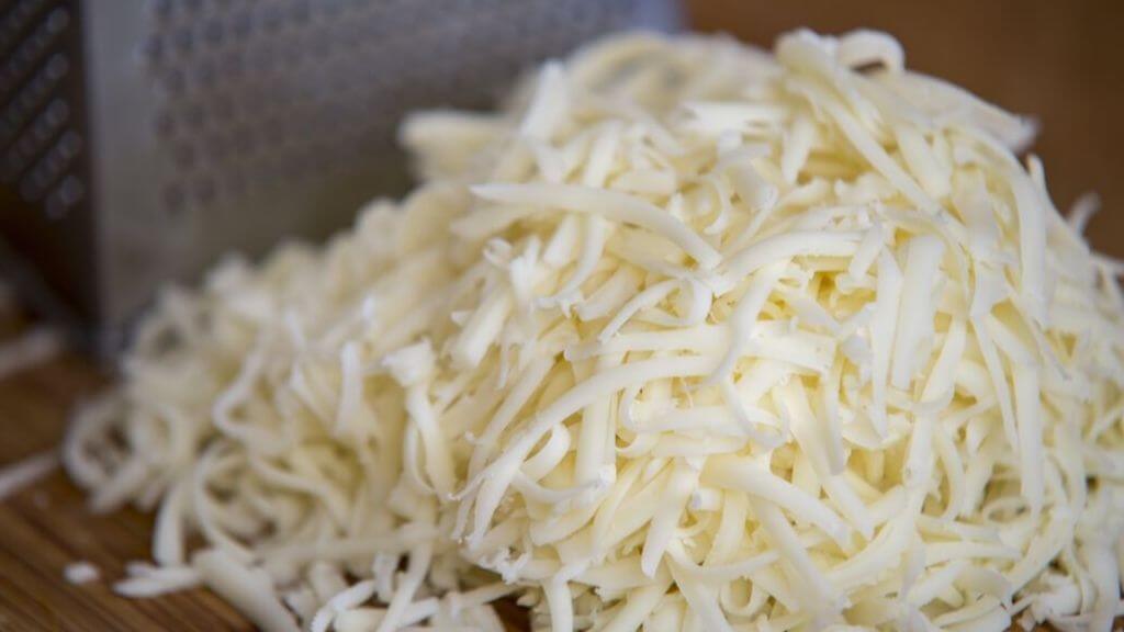 A pile of shredded Mozzarella cheese