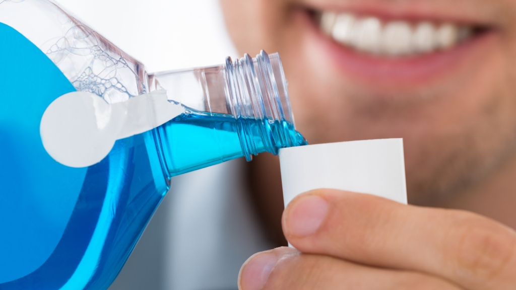 Man pouring mouth wash into the cap