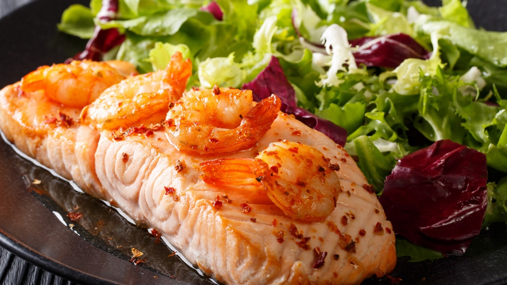 a plate of shrimp and salad