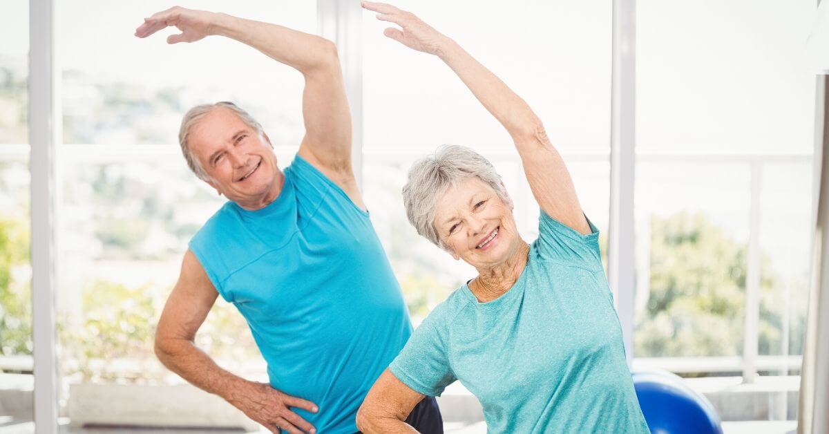 a mature couple stretching at a studio