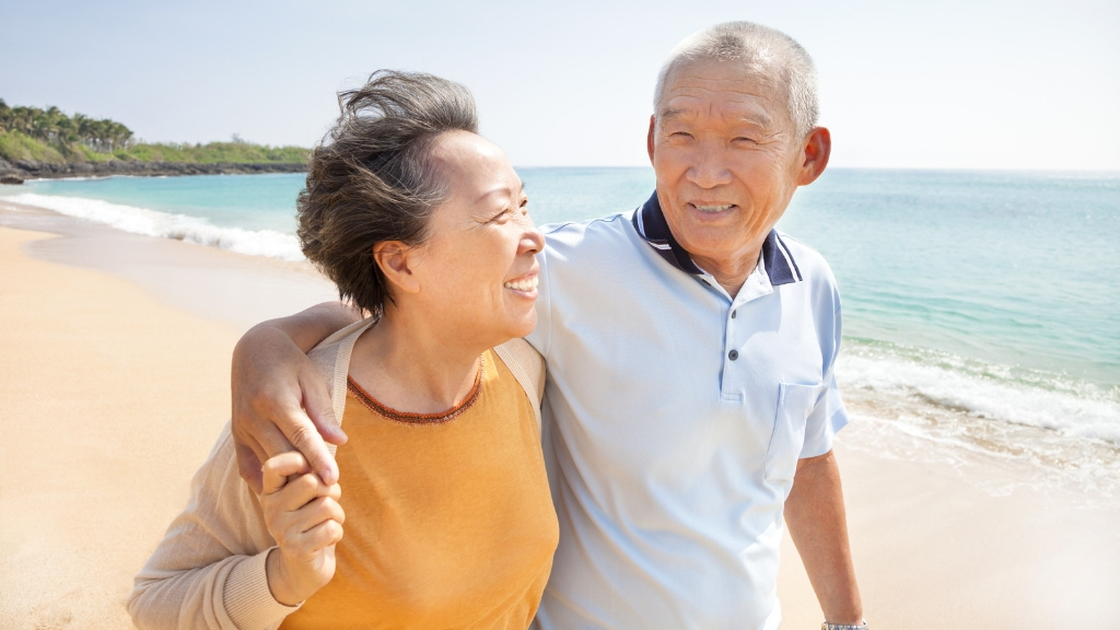 Senior couple enjoying a walk on the beach