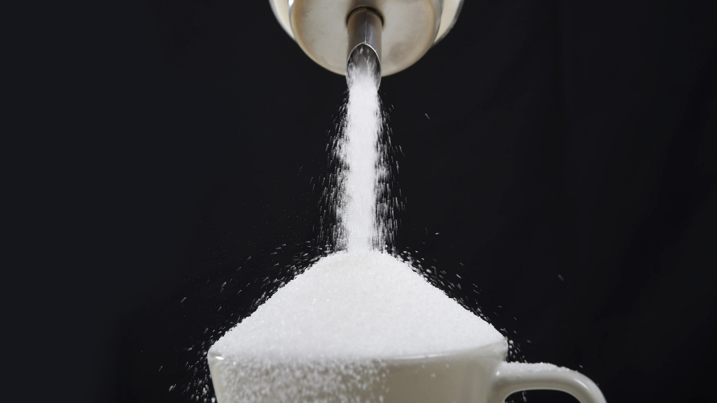 a close-up of a white liquid being poured into a glass